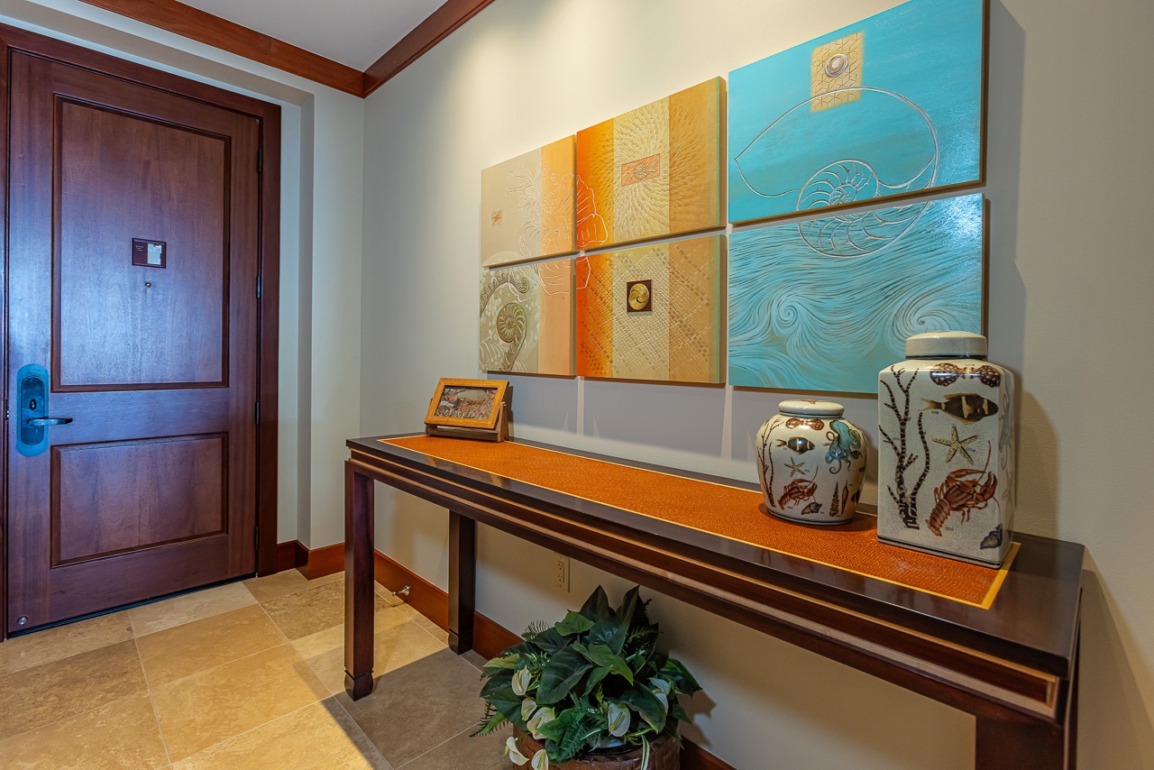 Step into your private retreat through this welcoming entry, where coastal-inspired artwork and decorative touches set a relaxing, tone from the moment you arrive.