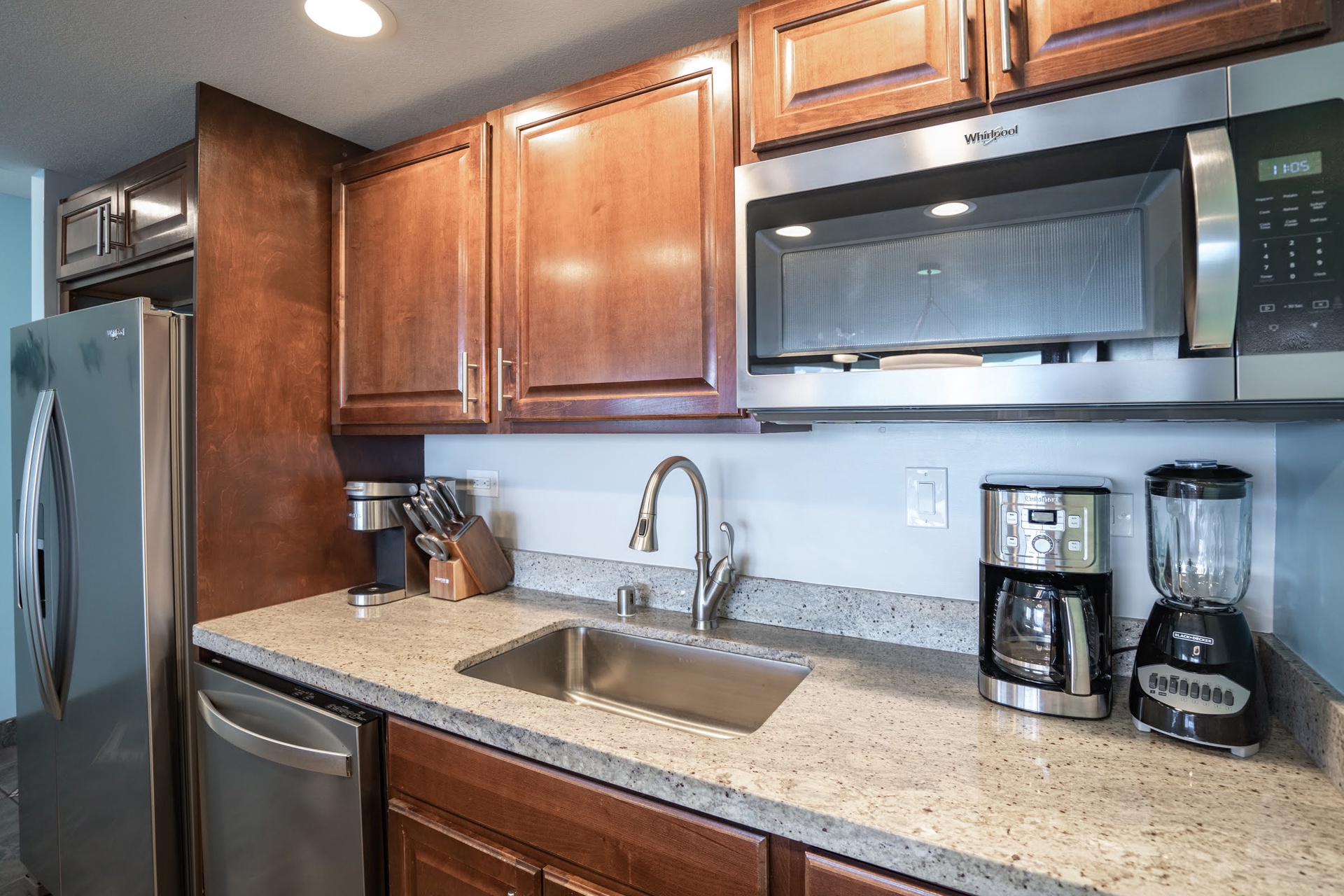 You'll appreciate the well-appointed kitchen with stainless appliances, granite countertops, and thoughtful touches like the coffee maker and blender ready for your morning routine.