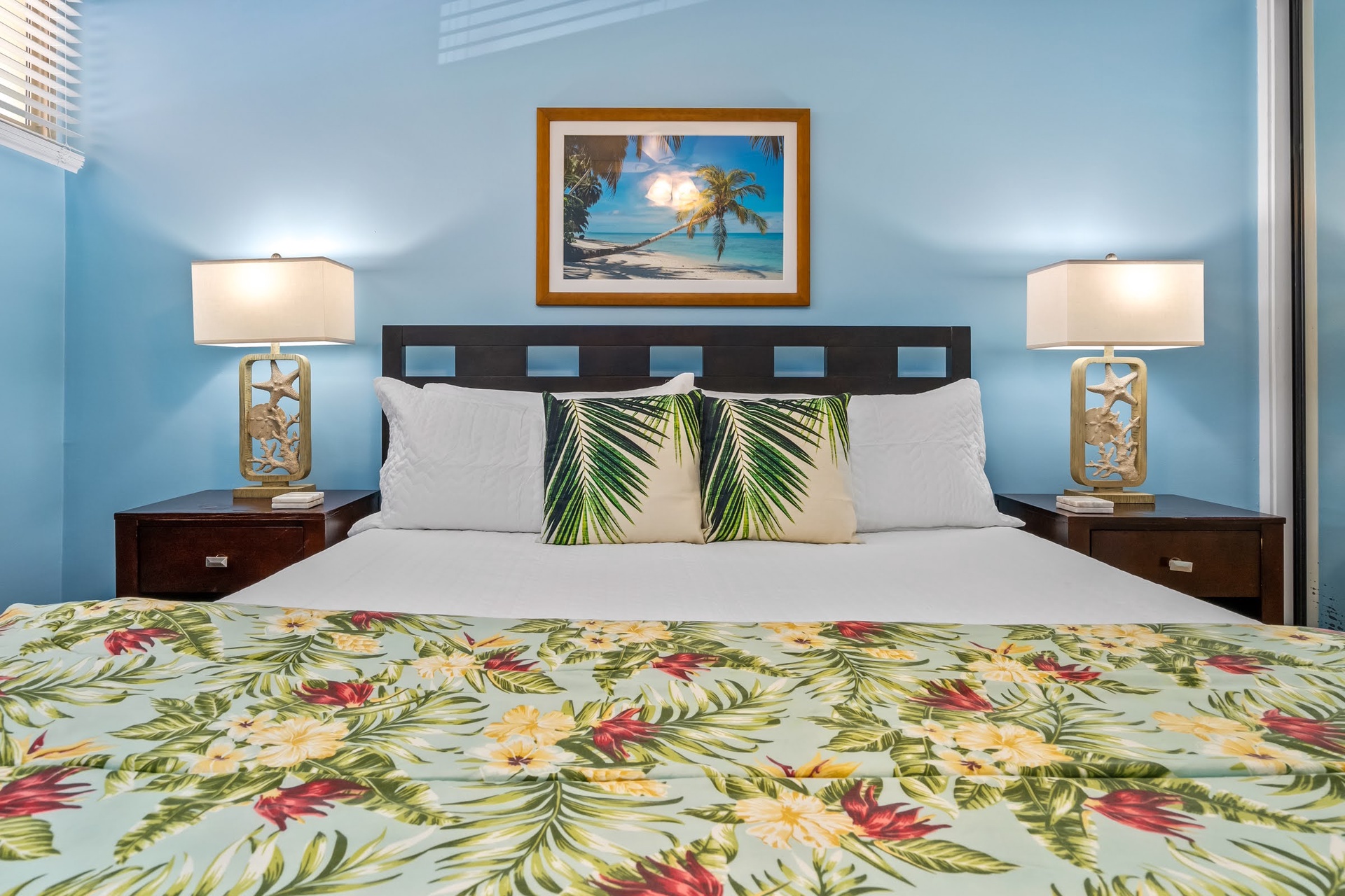 Drift off to sleep in your tropical-themed bedroom, where cheerful florals and soft blue walls invite you to unwind and recharge for tomorrow's adventures.