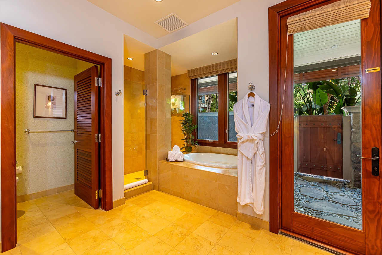 Step into your serene bathroom sanctuary with warm tropical wood tones, a luxurious soaking tub, and direct access to your private outdoor garden shower oasis.