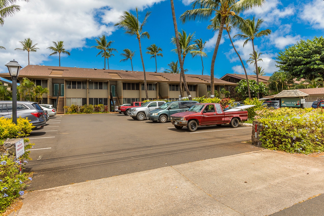 The property offers convenient parking surrounded by swaying palms and tropical landscaping, creating a welcoming arrival experience in a sunny island setting.