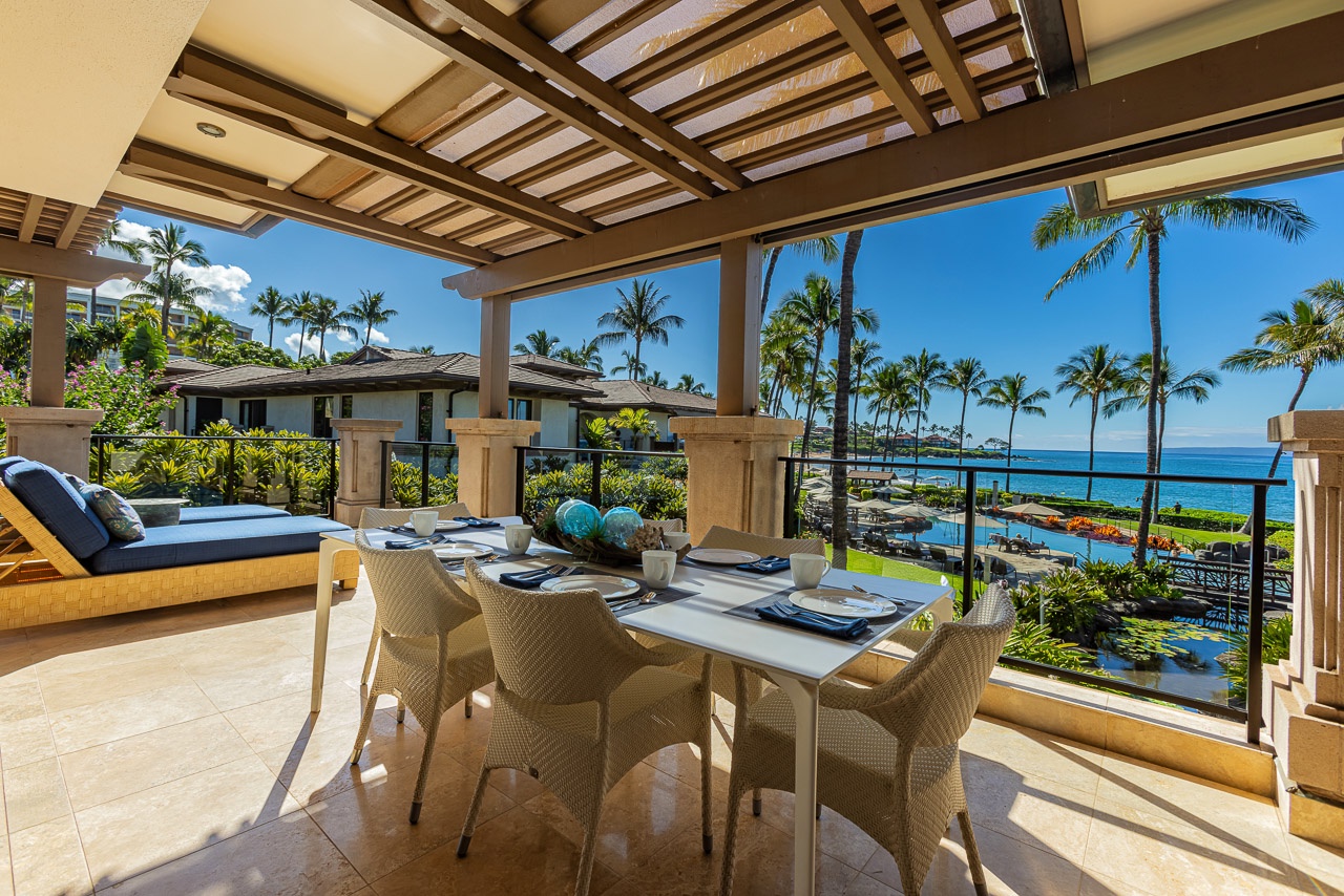 Picture yourself dining al fresco here, where the warm Hawaiian breeze mingles with ocean views and swaying palms. Gather around this elegant outdoor table, perfectly set for unforgettable meals under your private pergola.