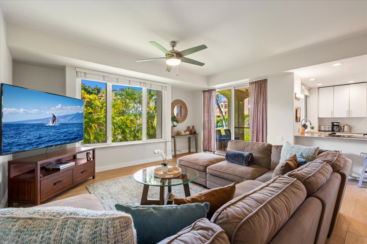 Bright island inspired living room with large Smart TV and AC