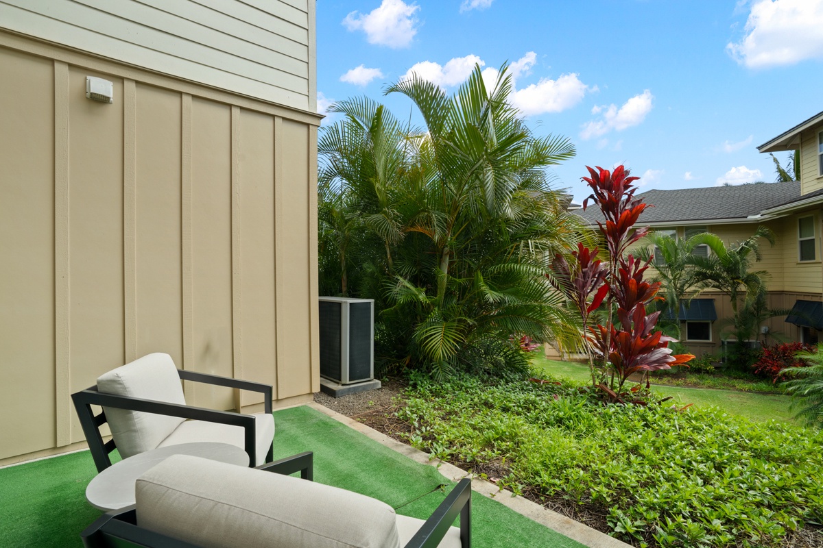 Unwind on your private patio surrounded by lush tropical gardens and vibrant flowering plants in this serene outdoor escape.