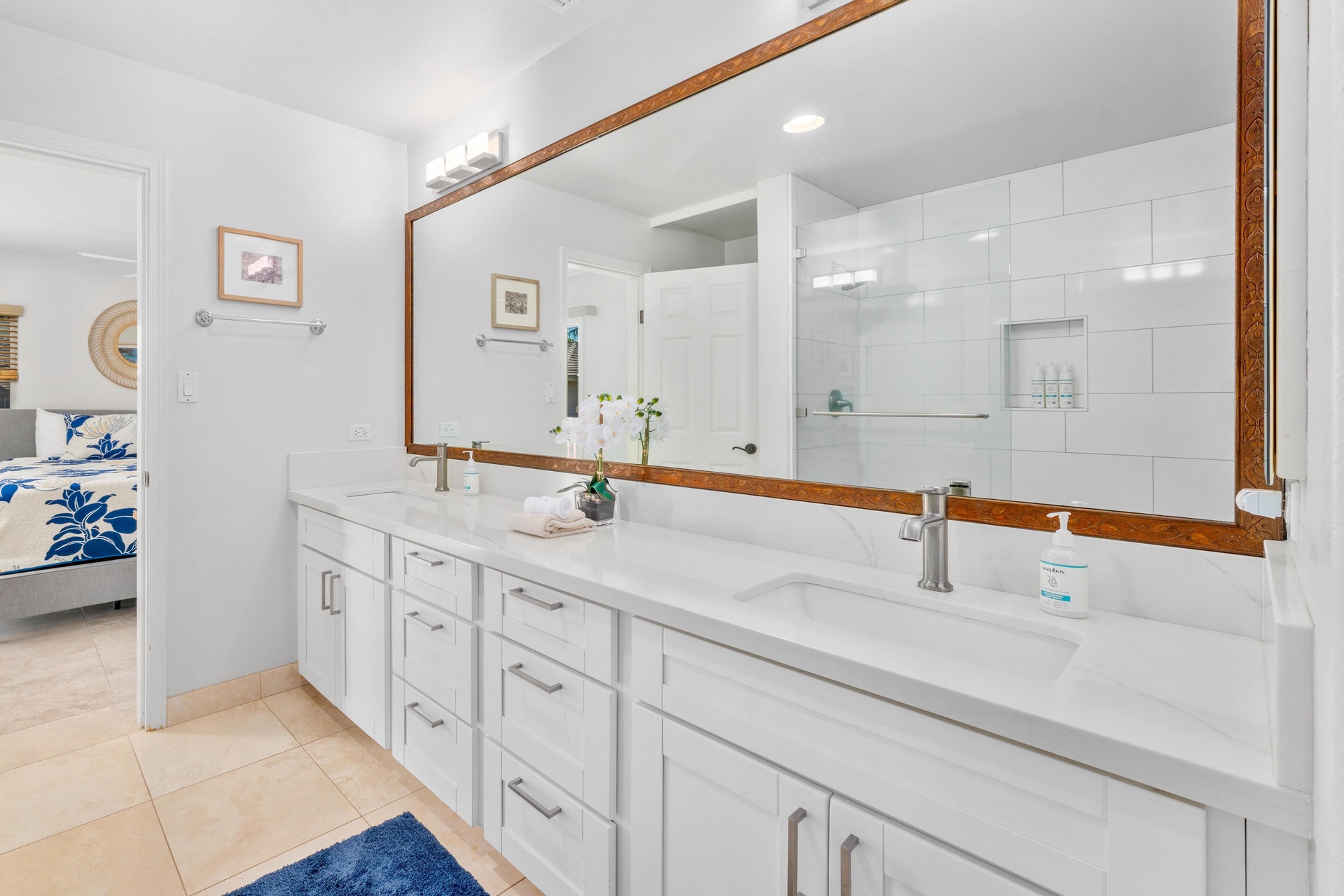 Step into your spa-like ensuite with dual vanities, marble countertops, and a luxurious walk-in shower—perfect for unwinding after beach days.
