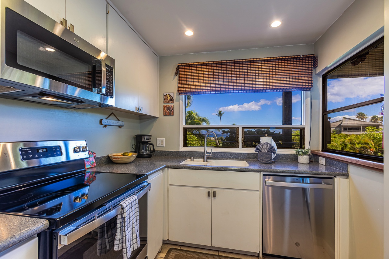 Your fully equipped kitchen features stainless steel appliances and opens to stunning views of tropical palms and blue skies—perfect for inspiring your morning coffee ritual or preparing island-fresh meals.