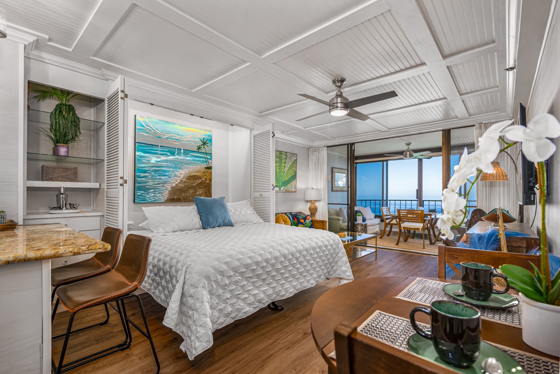 Wake up to breathtaking ocean views from your stylish bedroom with coffered ceilings and tropical touches.