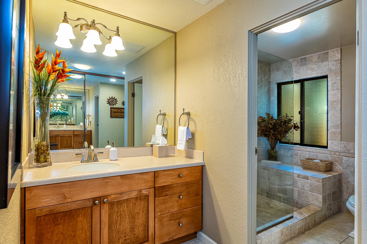 Your ensuite bathroom features a spacious vanity, warm lighting, and a beautifully tiled shower where you can unwind after a day of adventure.