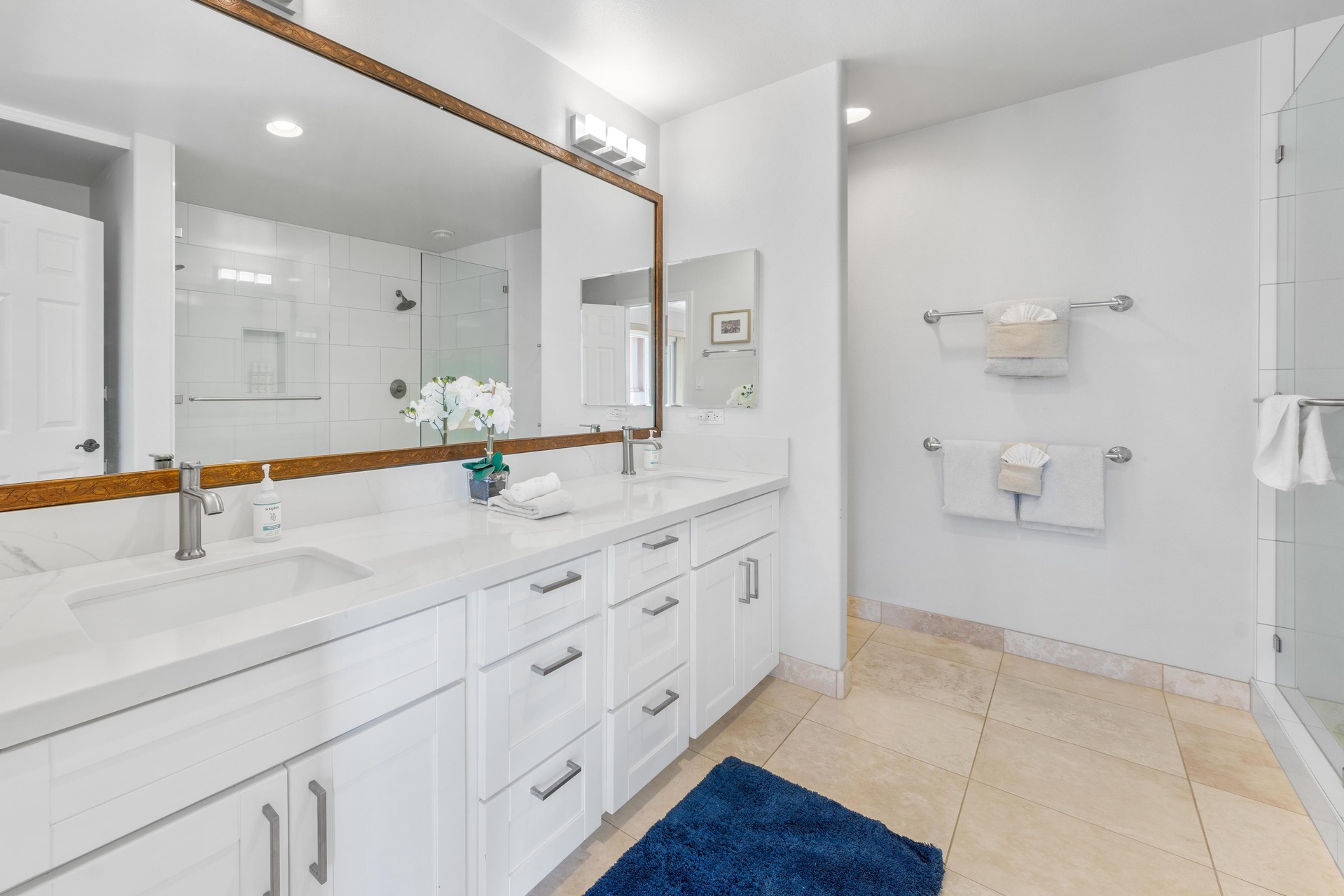 Your spacious bathroom features marble counters, dual sinks, and a glass-enclosed shower for luxurious morning routines.