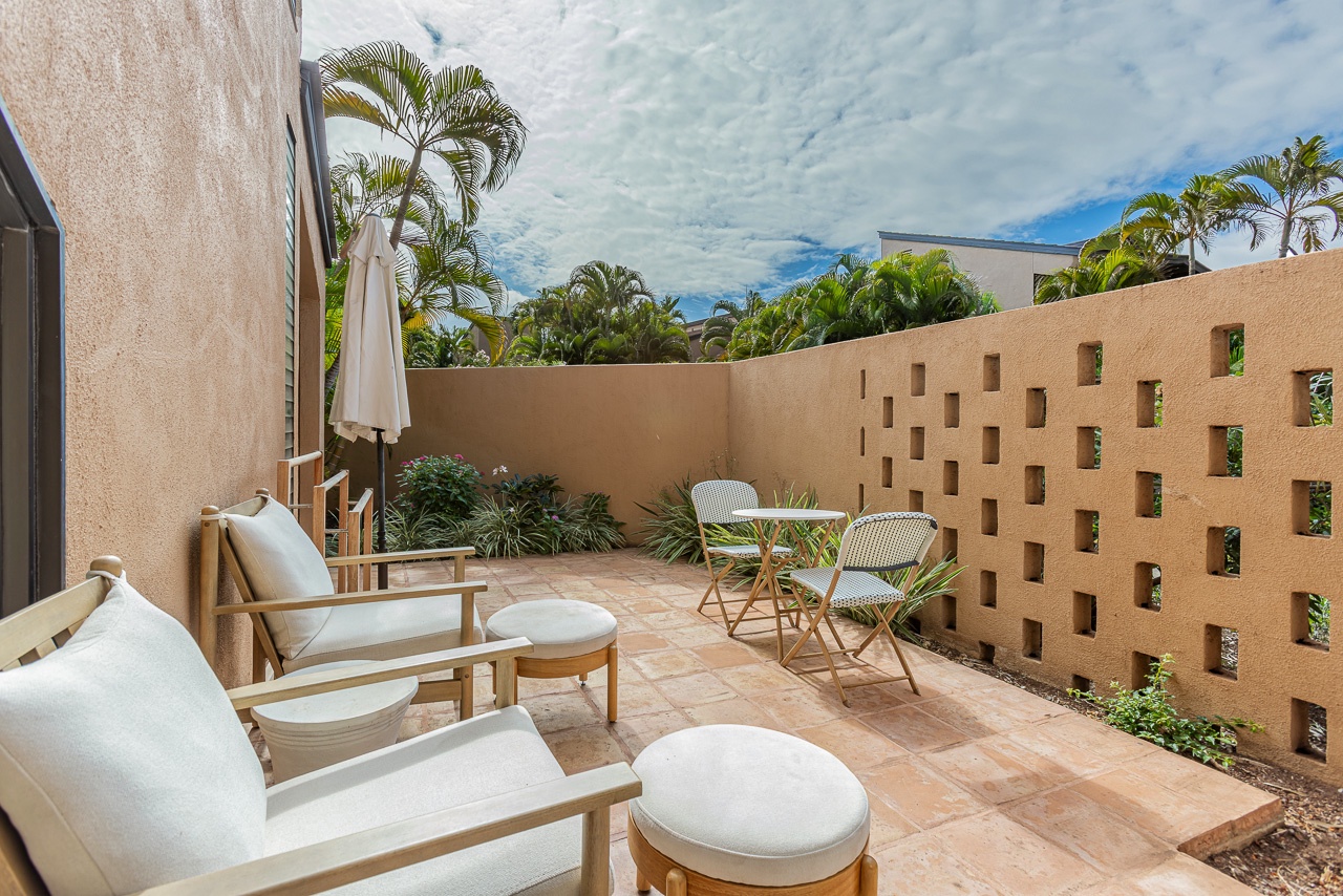 Relax outdoors in a bright lanai framed by lush Wailea greenery