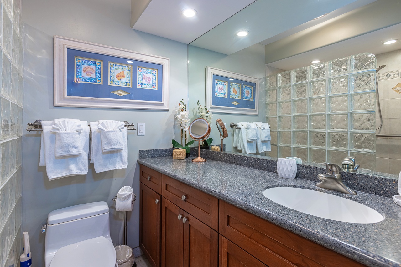 Refresh in your private bathroom with plush towels, granite counters, and soothing coastal-inspired accents that invite you to unwind after exploring.