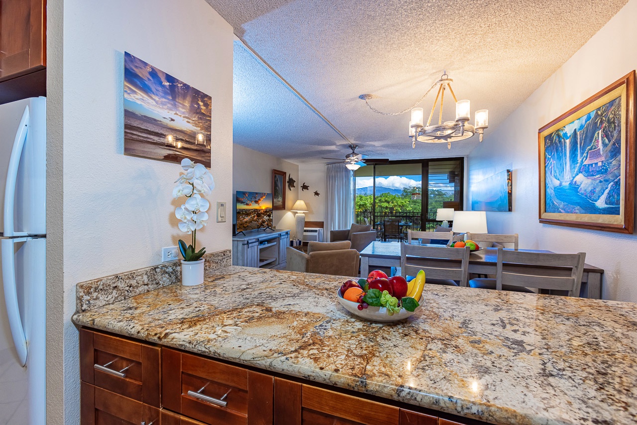 Step into your spacious condo where an elegant granite island sets the stage for easy meal prep and relaxed gatherings. Settle into the living area and take in lush greenery through the sliding doors—your perfect spot to unwind.