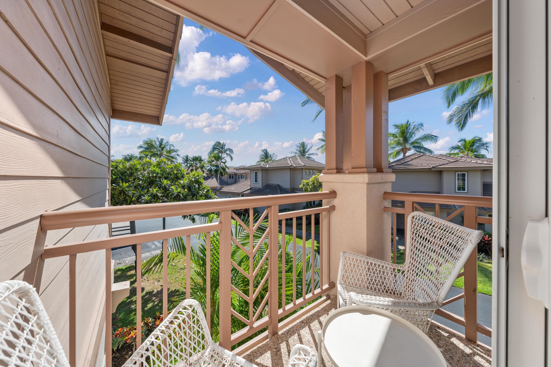 Step onto your private tropical balcony where palm-fringed views and comfortable seating create the perfect retreat.
