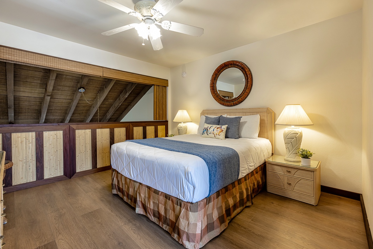 Your upstairs loft bedroom offers a peaceful retreat with exposed beam ceilings, warm wood tones, and soft lighting that creates a cozy ambiance for restful nights.