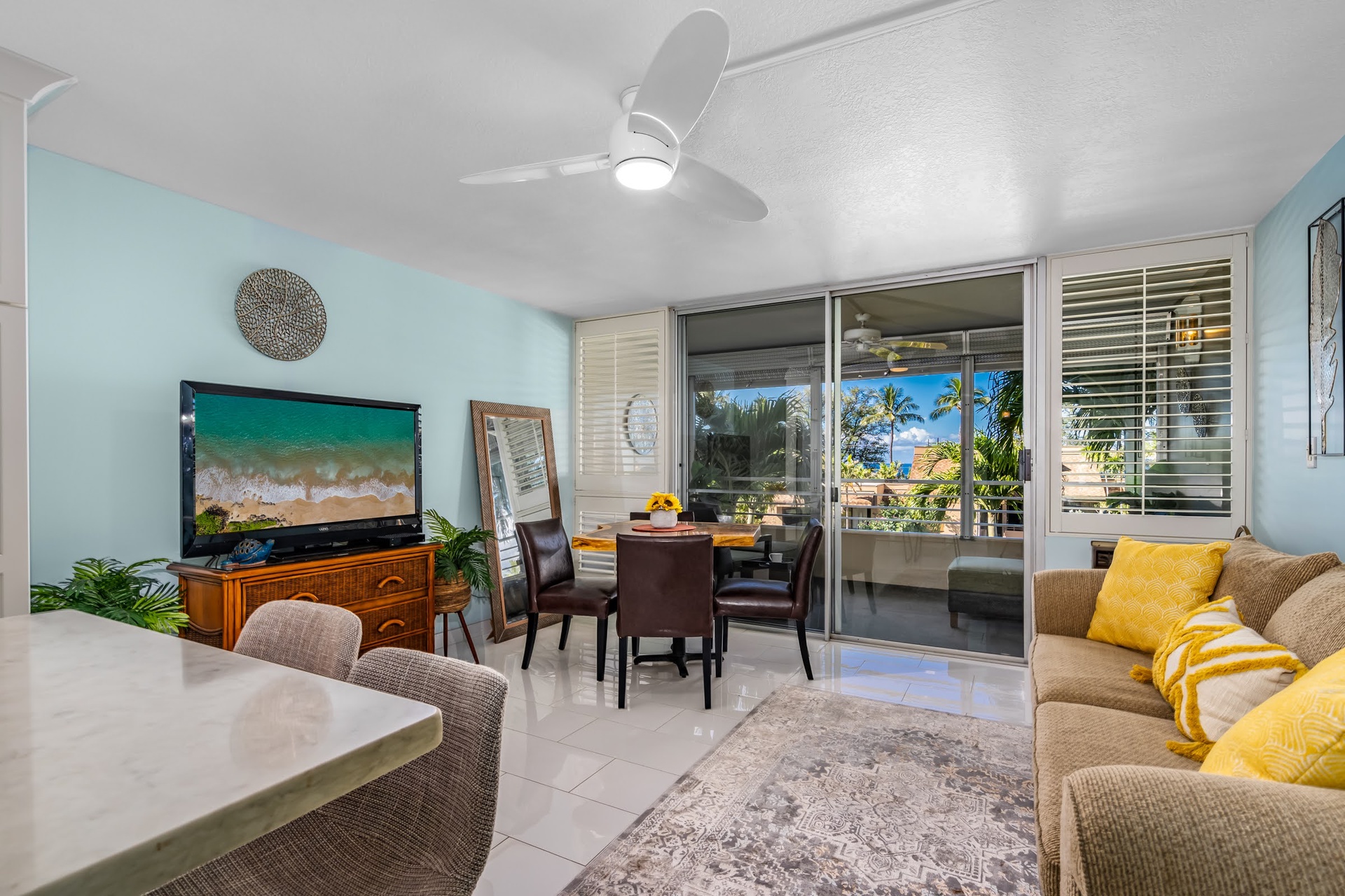 Settle into your bright, airy living space with coastal vibes and tropical views. Let the ceiling fan keep you cool as you relax in comfort, just steps from your private lanai overlooking palm trees.