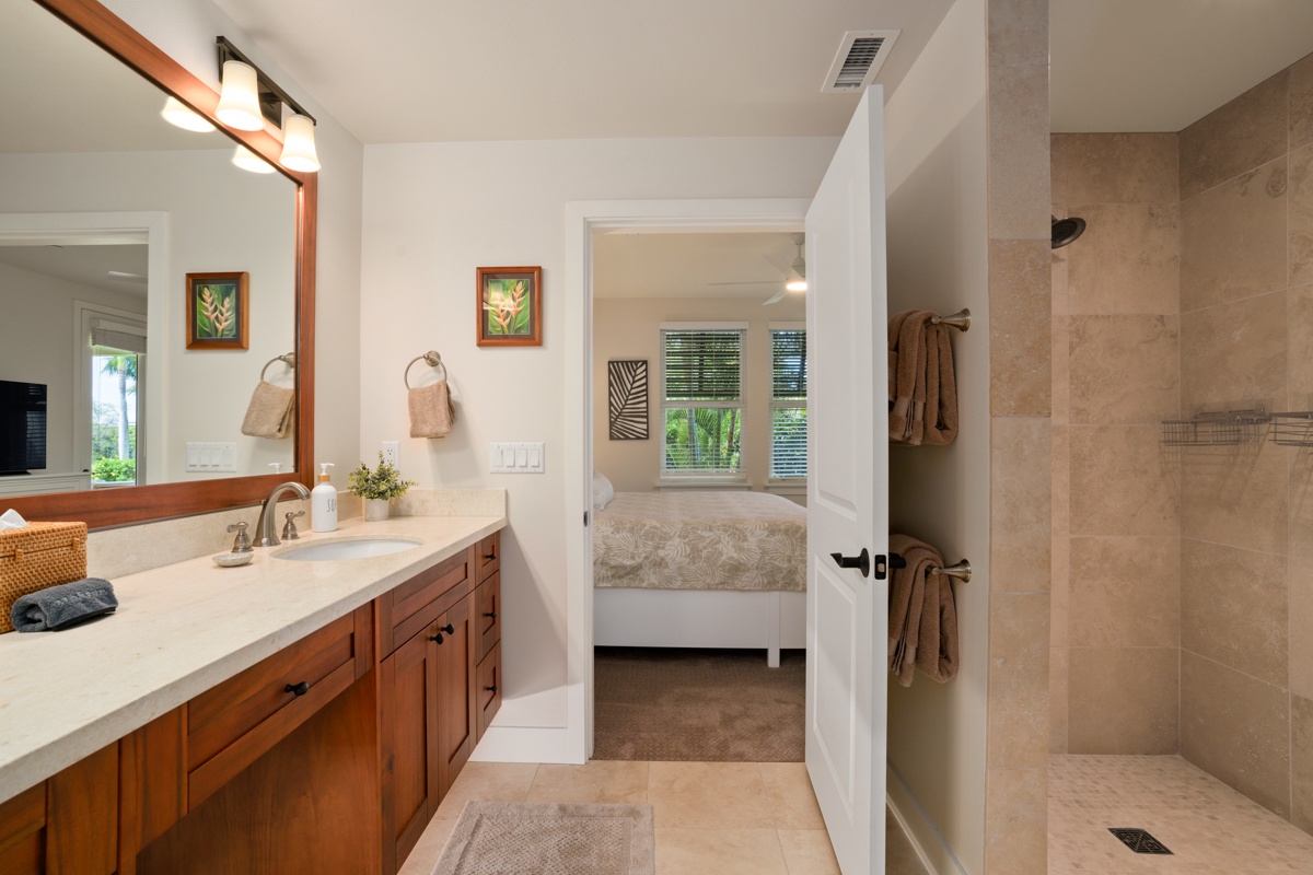 Step into your spa-like bathroom with warm wood vanity, oversized shower, and peaceful bedroom views—your perfect retreat awaits.