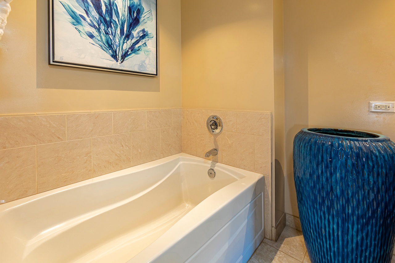Unwind in your private soaking tub after a day of exploration. The coastal-inspired décor and elegant blue accents create a serene spa-like retreat.