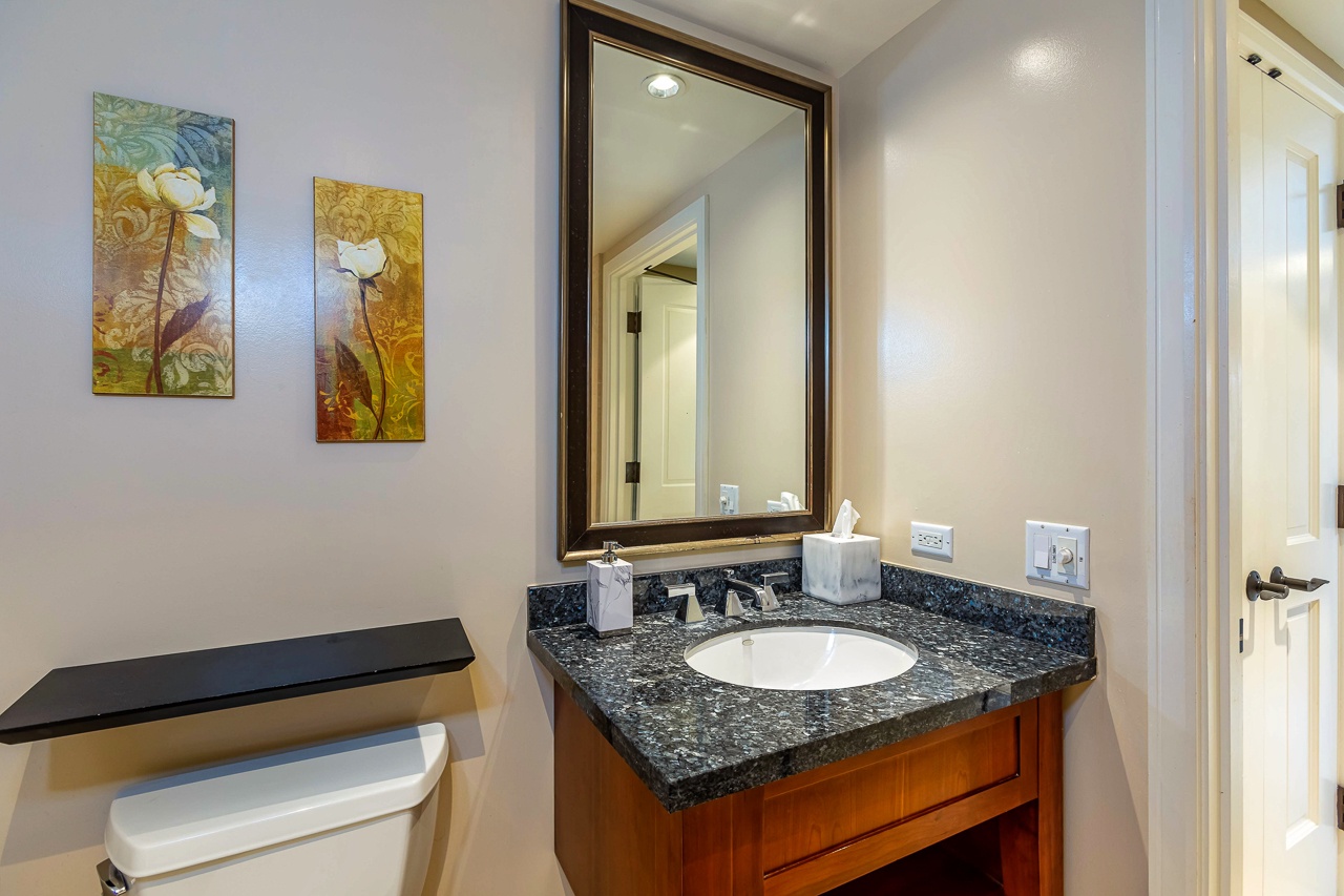 This bright, modern bathroom offers a granite vanity, framed mirror, and crisp white finishes—everything you need to refresh after your adventures.