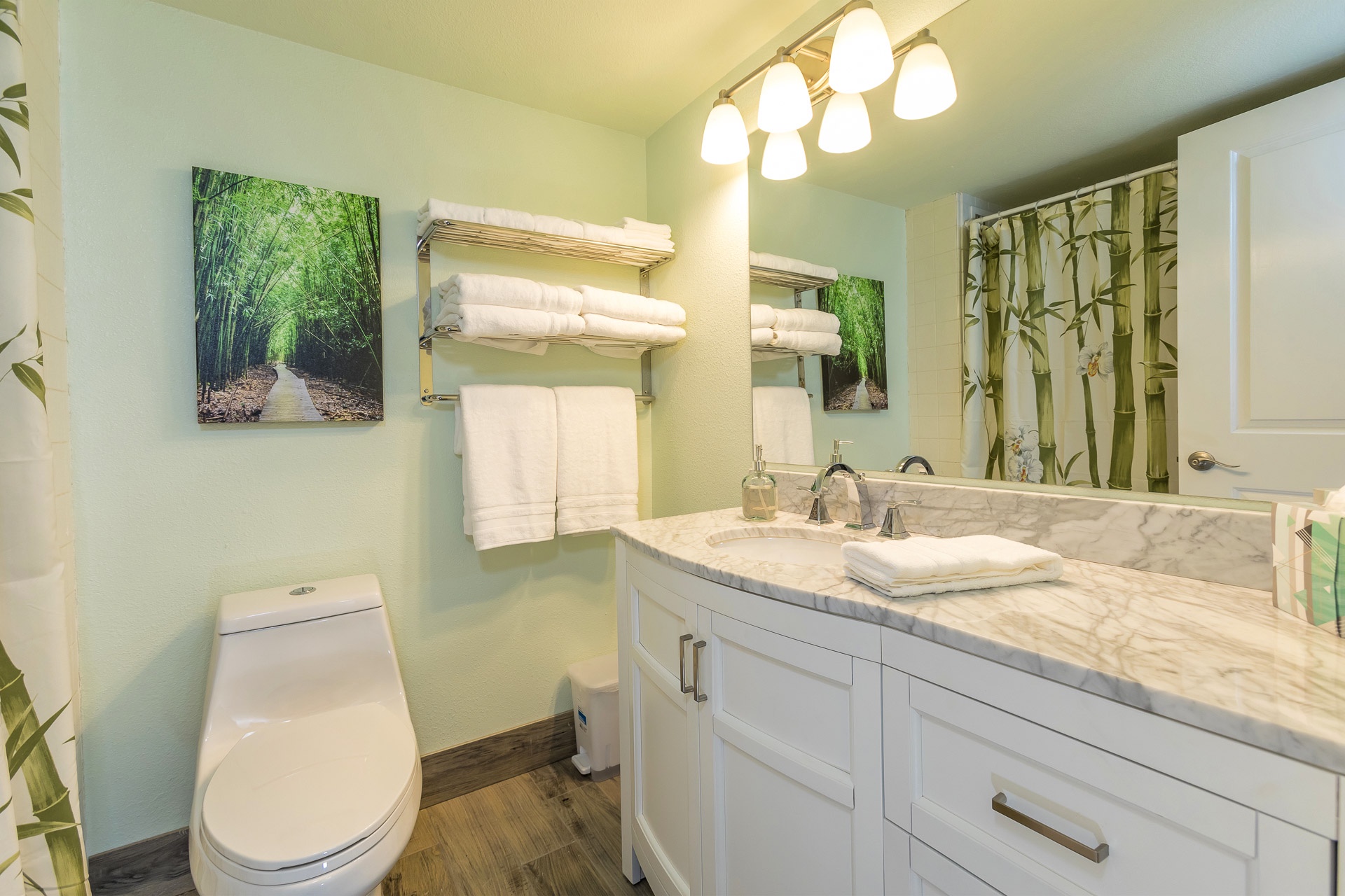 Freshen up in your serene bathroom featuring elegant marble countertops, fluffy towels, and tranquil bamboo accents that create a calming spa-like retreat.