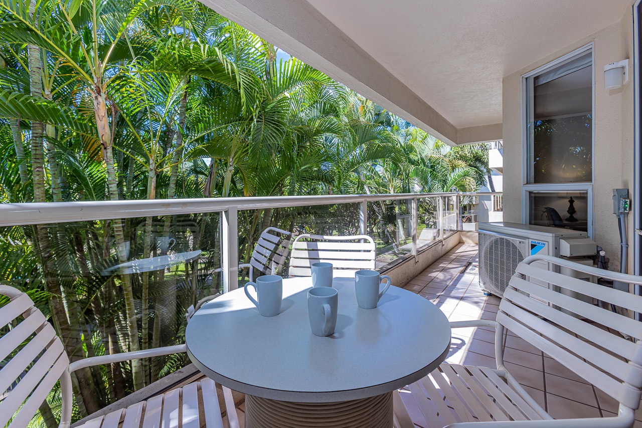 Peaceful lanai surrounded by lush tropical greenery