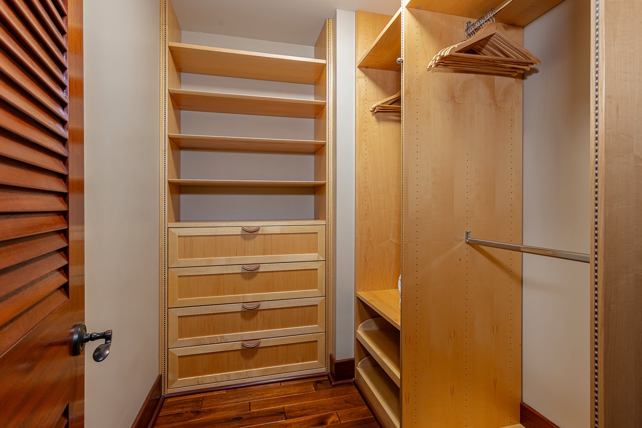 Step into your spacious walk-in closet with custom built-in shelving, drawers, and dual hanging rods—plenty of room to unpack and settle in for your stay.