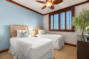 Rest easy in this cozy twin bedroom with soft linens, tropical touches, and plenty of natural light.