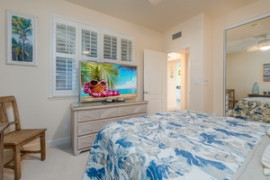 Guest bedroom with a queen bed and TV.