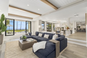 Bright open living room with seamless access to the poolside patio for effortless indoor-outdoor living.