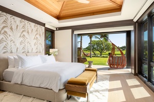 Awaken to stunning garden views from this luxurious primary suite (#1), opening onto the tropical paradise beyond.