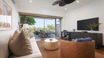 Seamless indoor-outdoor living in the family den with a sliding glass pocket door that leads to the lanai.