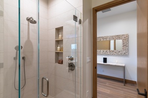 It also offers a separate walk-in shower in a glass enclosure.