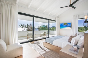Enjoy the light-filled guest bedroom with own balcony and modern furnishings.