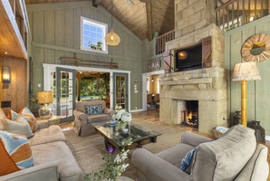 The main living area features vaulted high ceiling and a fireplace.