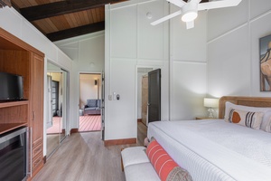 The lockout bedroom features a plush king bed, calming tropical tones, and full A/C comfort—making it a peaceful retreat within the home.
