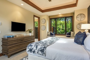 Reverse view of the third guest room showcasing king-sized bed and built in window seating.