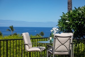Private lanai with a bistro set, offering a peaceful retreat with panoramic coastline views.
