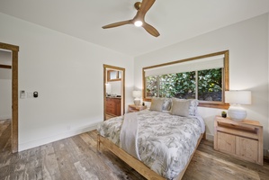 Restful guest bedroom with garden views and minimalist island-inspired decor.