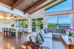 The open living area seamlessly connects to the dining space and lanai, allowing guests to enjoy easy indoor/outdoor living throughout their stay.