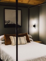 Recharge in the serene bedroom with soft lighting and modern cabin-inspired design.