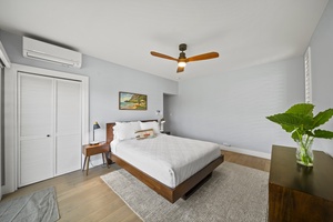 Bedroom featuring a queen-sized bed, modern decor, and private garden access.