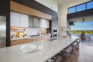 Entertaining and meal prepping made easy with this spacious kitchen and expansive bar countertop.