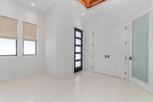 Sunlit bonus room with privacy doors and access to outdoor entertaining areas.