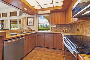 Take in ocean glimpses from the kitchen at Kapalua Ridge 2321, complete with rich cabinetry and modern design.