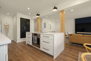 Central marble island perfect for gathering while cooking, connecting seamlessly to the living and dining spaces for effortless entertaining.