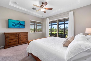 The primary suite has a king bed, TV, central AC and natural lighting.