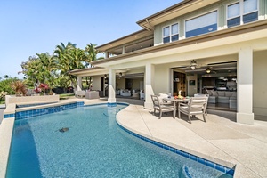 Sparkling pool with a covered patio, blending indoor-outdoor living