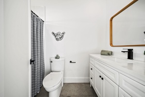 The ensuite bathroom has a single vanity and a separate shower for convenience.