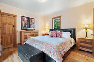 A cozy bedroom adorned with a colorful quilt, plush pillows, and a warm ambiance perfect for restful nights.