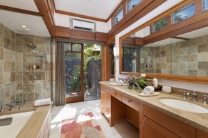 The ensuite bathroom includes a soaker tub, a tiled glass wall-enclosed shower, dual vanity, and high ceilings.