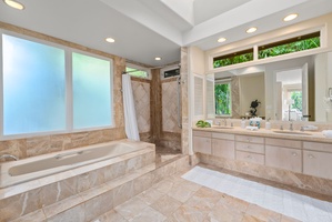 Luxurious marble bathroom with soaking tub and separate shower awaits your relaxation moments.